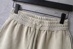 Beige shorts with elastic waistband and drawstring ties