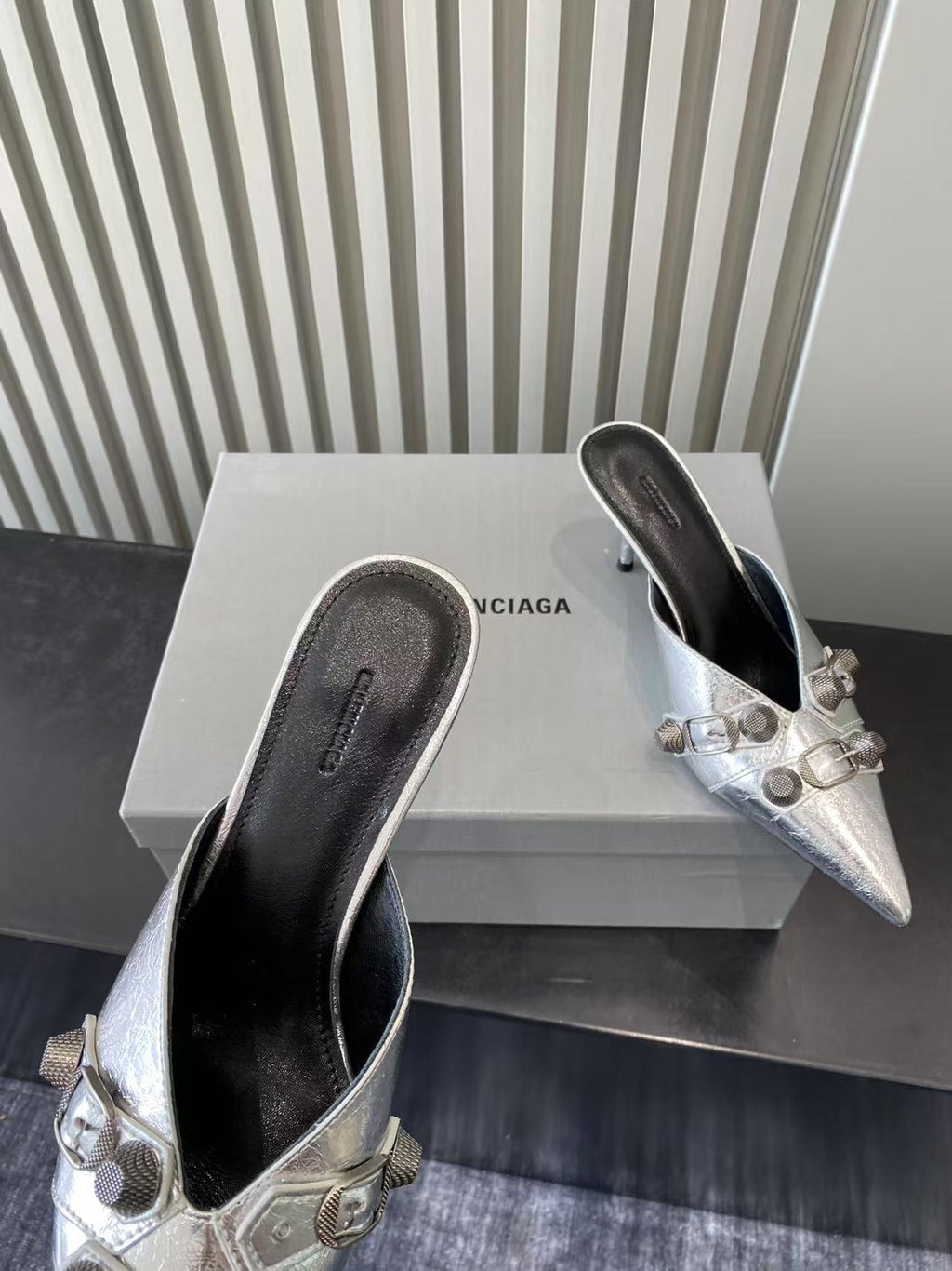 Metallic silver heeled sandals, dark interior and buckle strap hardware