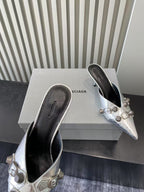Metallic silver heeled sandals, dark interior and buckle strap hardware