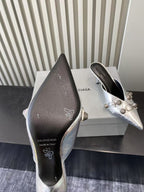 Metallic silver heeled sandals, dark insole with printed brand icons