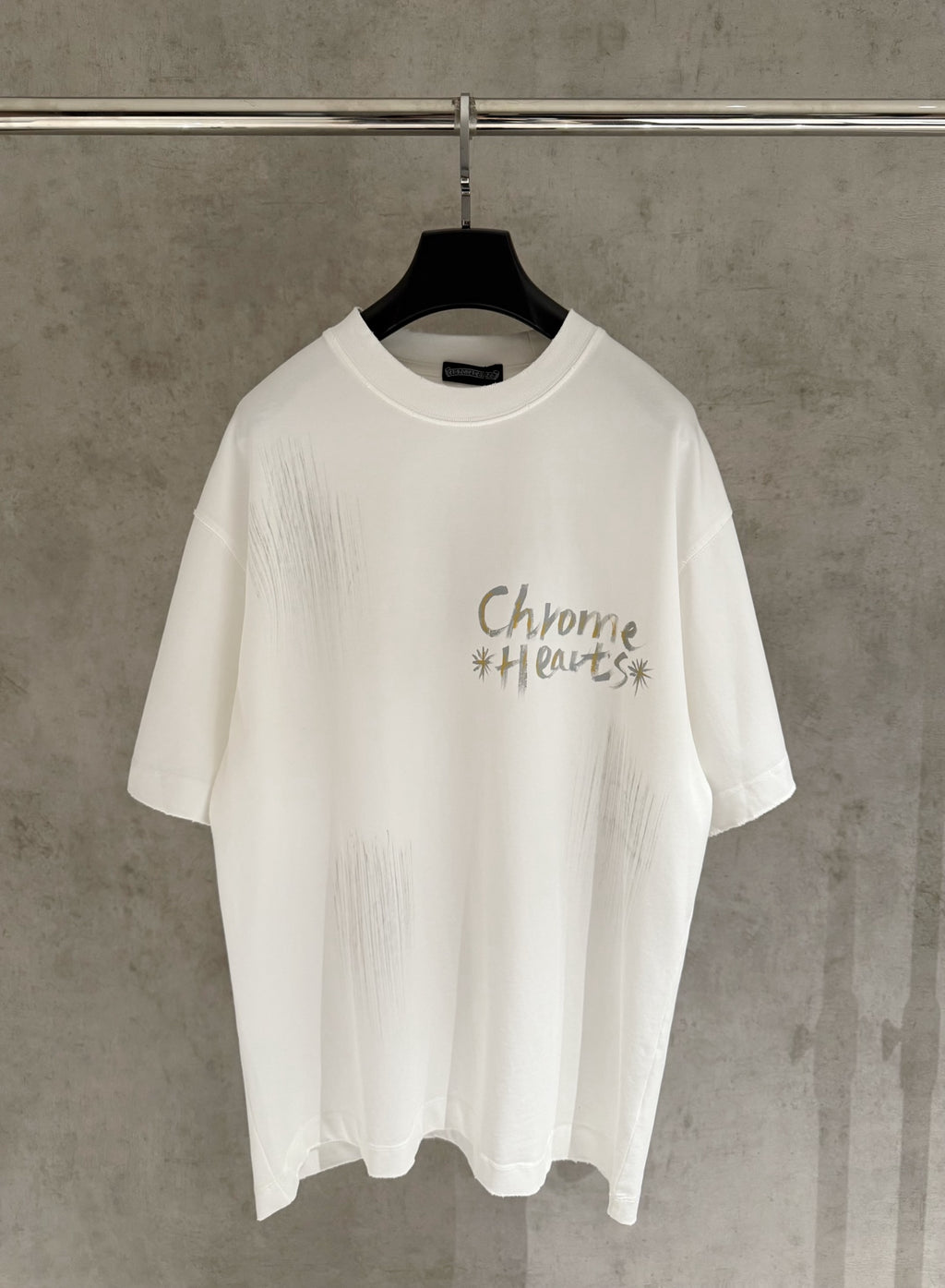 White short-sleeve graphic T-shirt with “Chrome Hearts” text on the chest