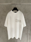 White short-sleeve graphic T-shirt with “Chrome Hearts” text on the chest