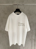 White short-sleeve graphic T-shirt with “Chrome Hearts” text on the chest