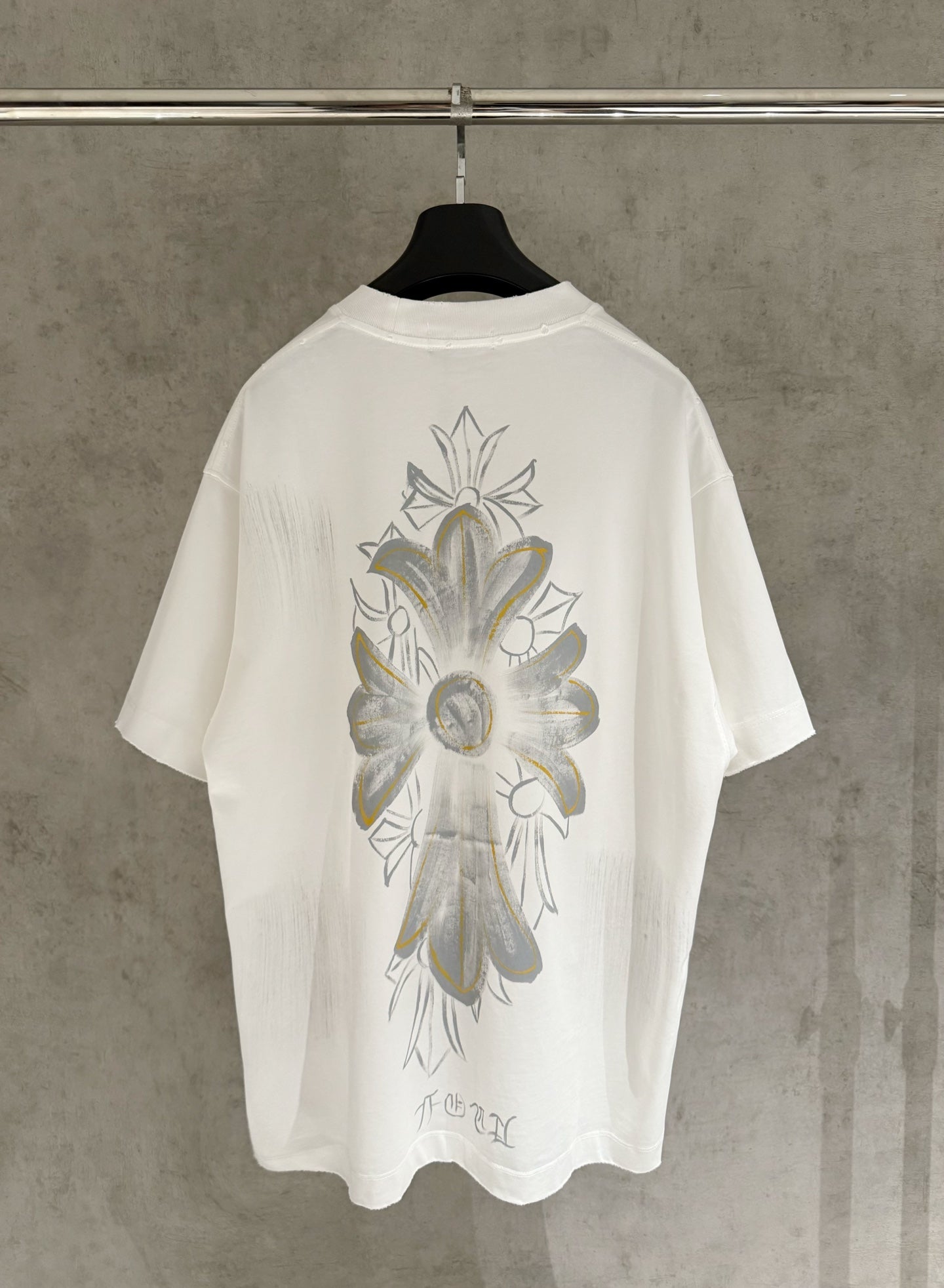 White short-sleeve T-shirt with large back floral graphic in gray and gold tones