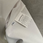 White T-shirt close-up of inside neck label and care tag