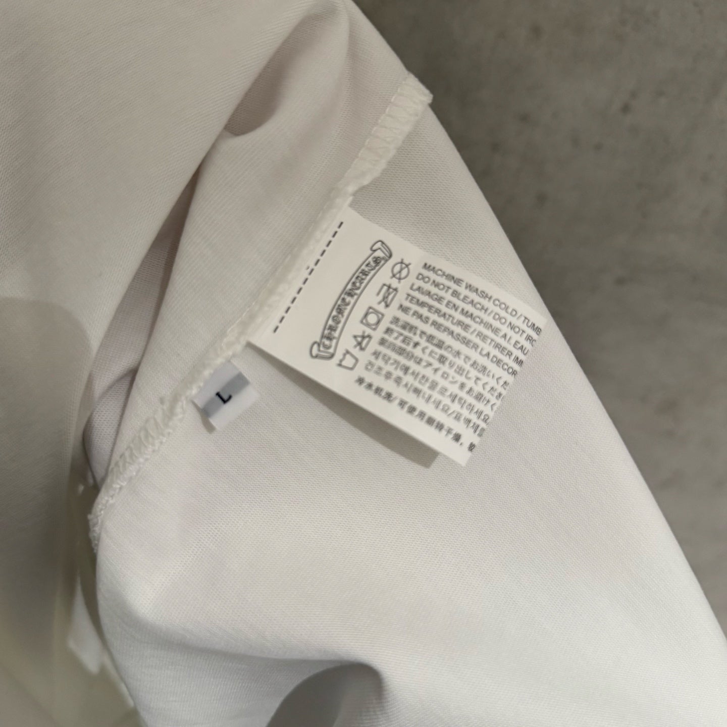 White T-shirt close-up of inside neck label and care tag