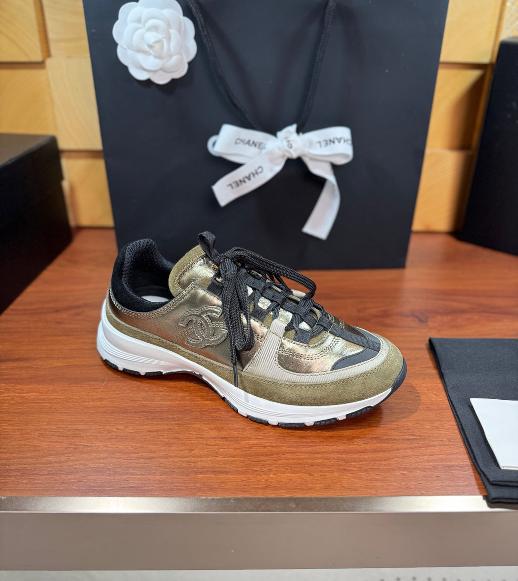 Chanel lace-up sneakers in olive-gold with black laces and white rubber sole