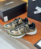 Chanel sneakers with olive-gold panels, black laces, and white midsole