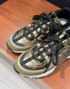 Chanel lace-up sneakers close-up with olive-gold uppers and black lace panels