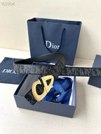 Dior belt with dark monogram strap and gold-tone buckle, box view.
