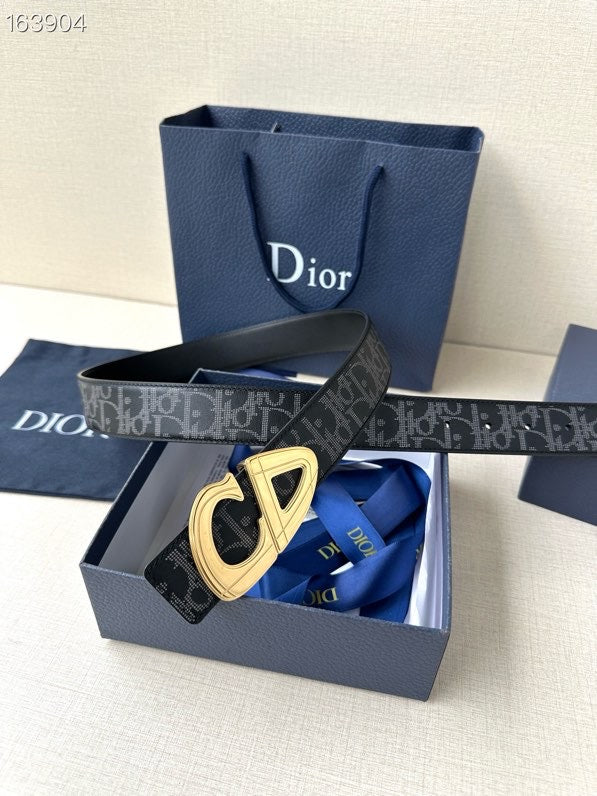 Dior belt with dark monogram strap and gold-tone buckle, box view.