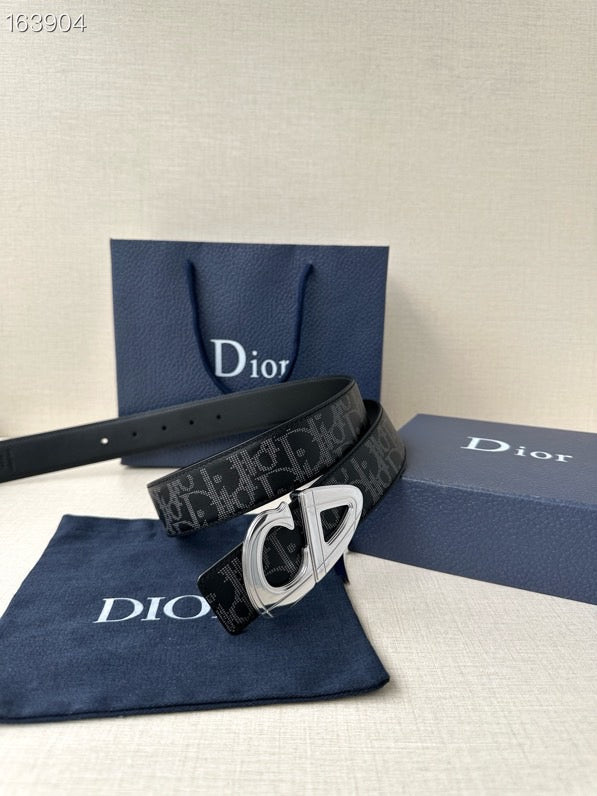 Dior belt with dark monogram strap and silver-tone buckle, laid flat.