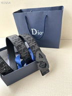 Dior belt with dark monogram strap and gray-toned buckle, angled view.