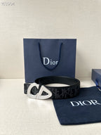Dior belt with dark monogram strap and gold-tone CD buckle.