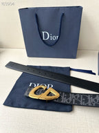 Dior belt with gold-tone buckle and dark monogram strap with punched holes.
