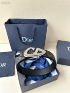 Dior belt in box with dark monogram strap and gold-tone buckle.