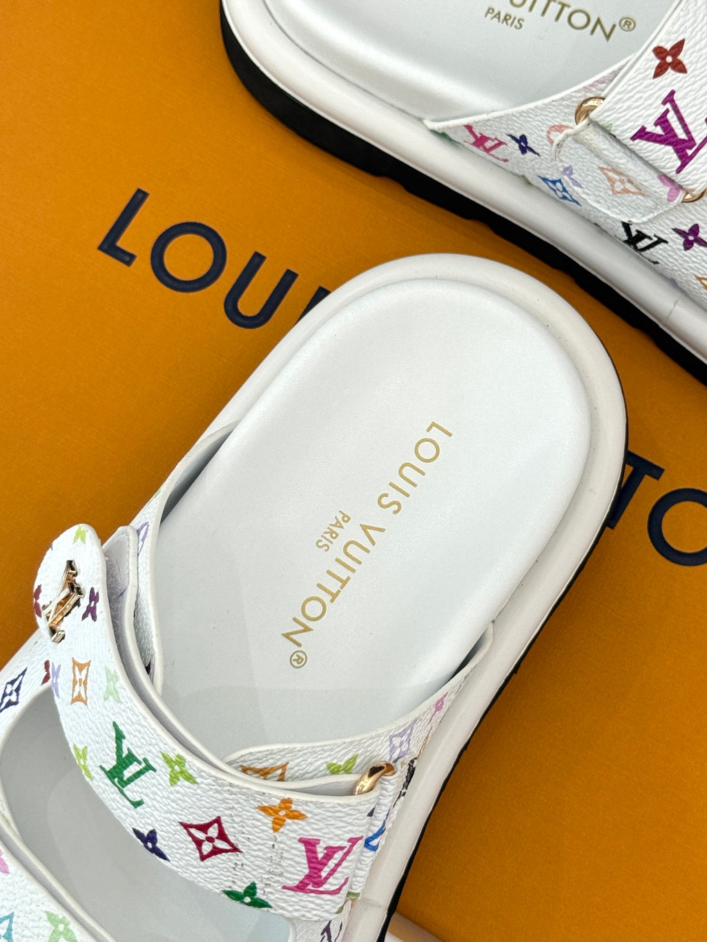 White slide sandal footbed with Louis Vuitton text and multicolor monogram strap