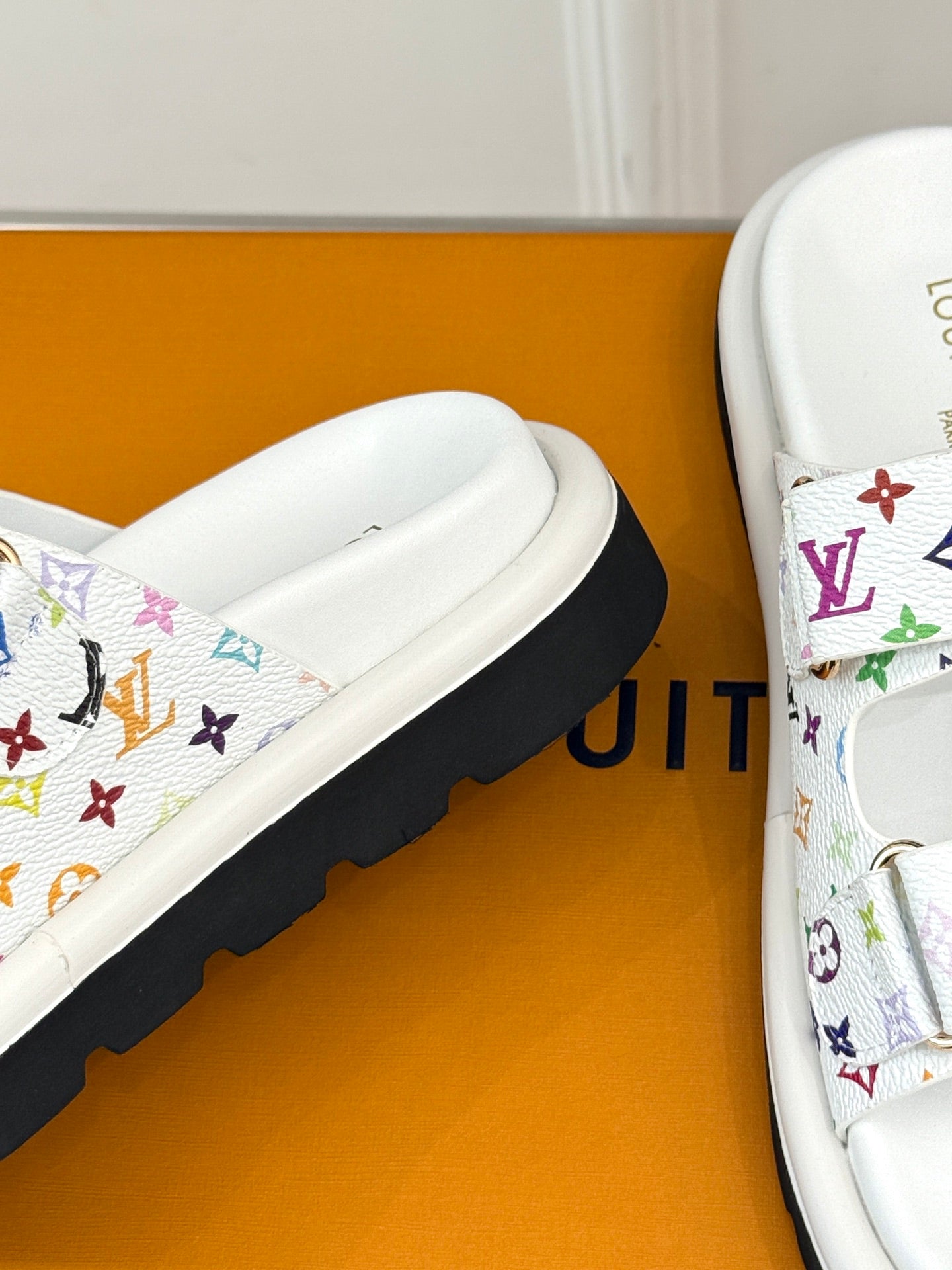 White slide sandal with multicolor monogram strap and cushioned footbed