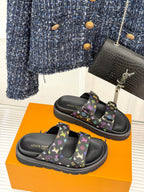 Pair of black Louis Vuitton slide sandals with multicolor monogram print and thick sole