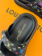 Close-up of Louis Vuitton slide sandal footbed with gold logo text