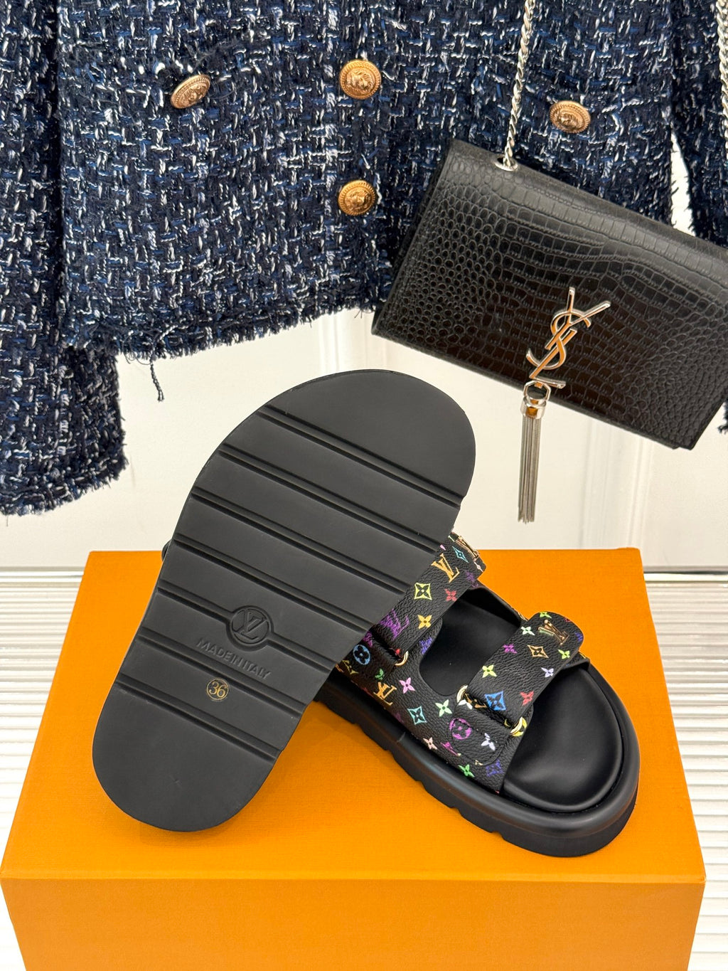 Sole view of black Louis Vuitton slide sandals with multicolor monogram straps