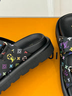 Close-up of black Louis Vuitton slide sandal with multicolor monogram strap