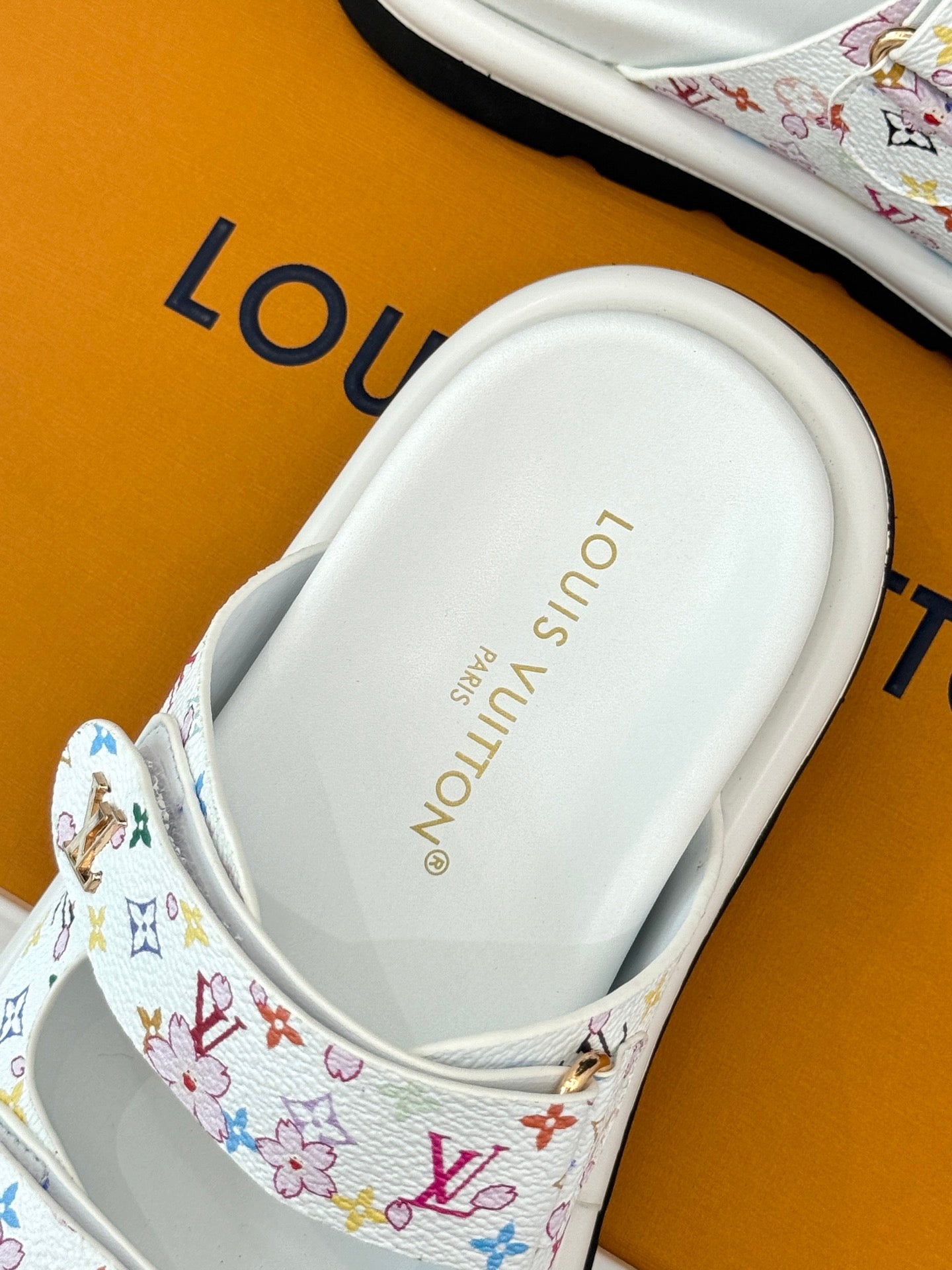 Louis Vuitton ladies luxury shoes, white footbed view with logo text on sandal