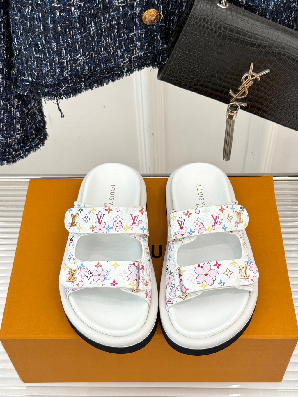 Louis Vuitton ladies luxury shoes, front view of white slide sandals with multicolor logo print