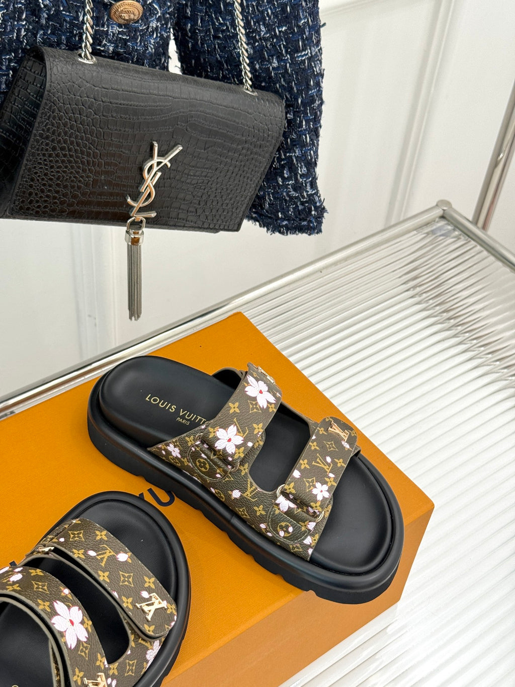 Ladies slide sandals with dark monogram floral straps and black open-toe slides