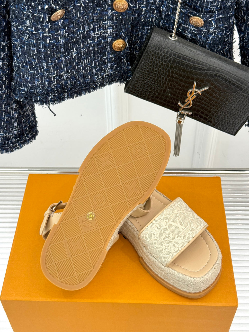 Beige espadrille sandals with white monogram straps and visible sole tread
