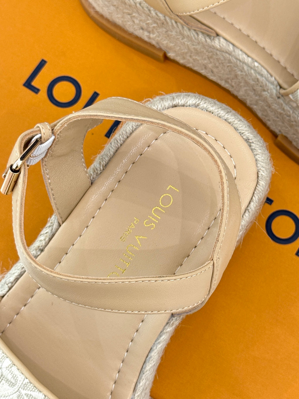 Close-up of beige espadrille sandal with top strap and adjustable ankle band