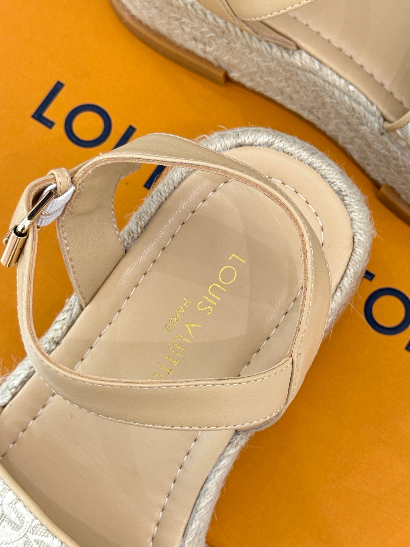 Close-up of beige espadrille sandal with top strap and adjustable ankle band