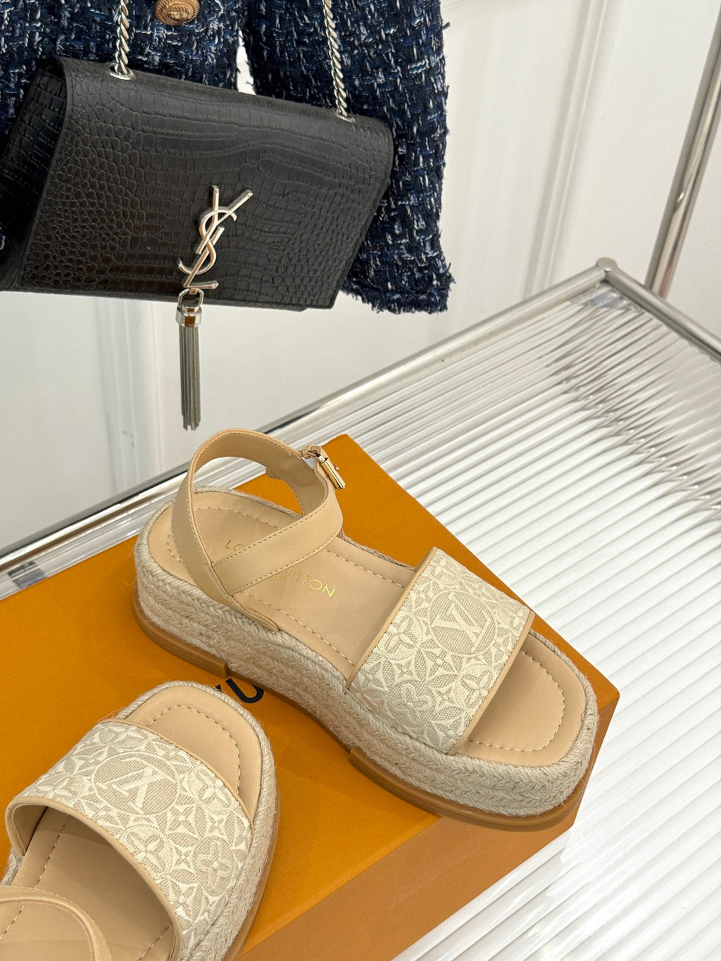 Beige espadrille sandals with white monogram straps on a braided platform sole