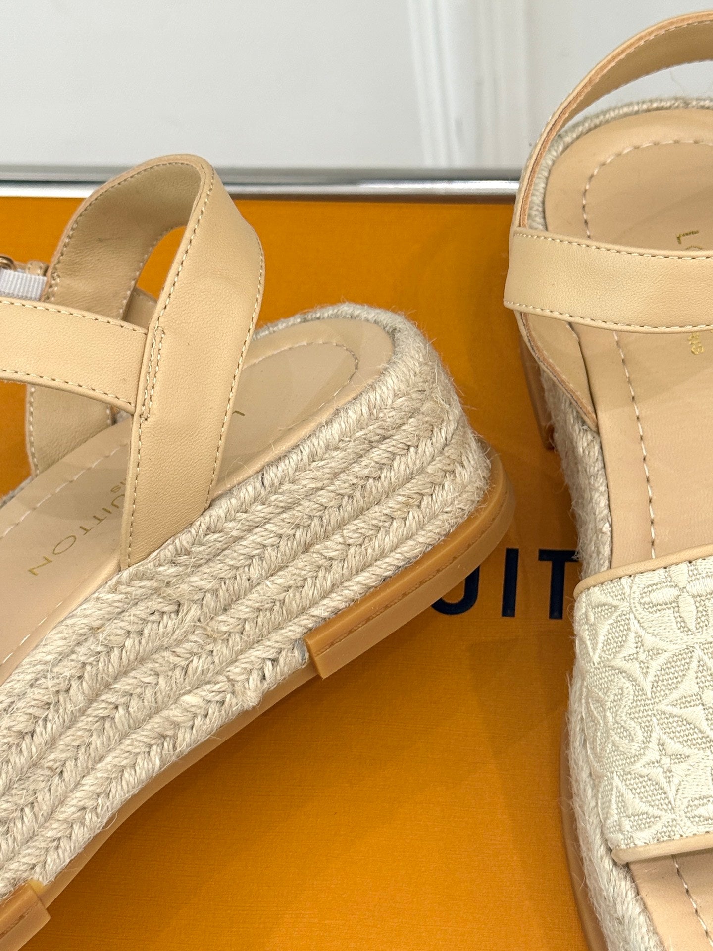 Close-up of beige espadrille platform sandal with braided rope wedge