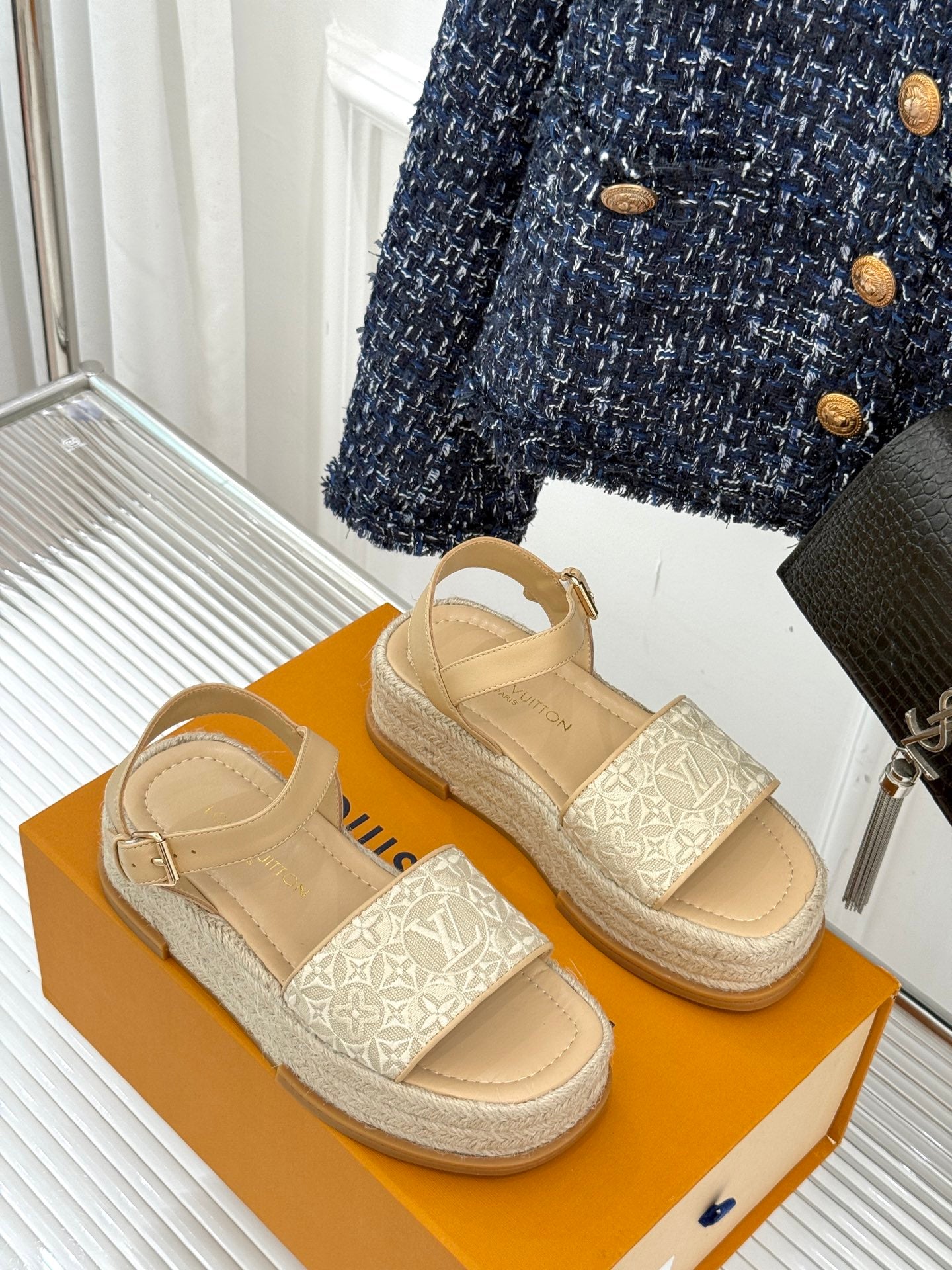 Beige platform espadrille sandals with monogram strap details and ankle straps