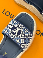 Blue slide espadrille sandal with monogram patterned toe strap and navy leather upper