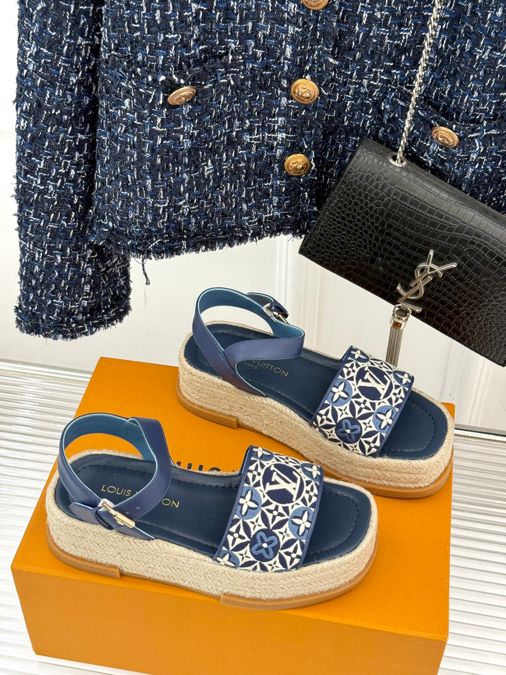 Pair of blue espadrille sandals with monogram canvas front straps on jute sole