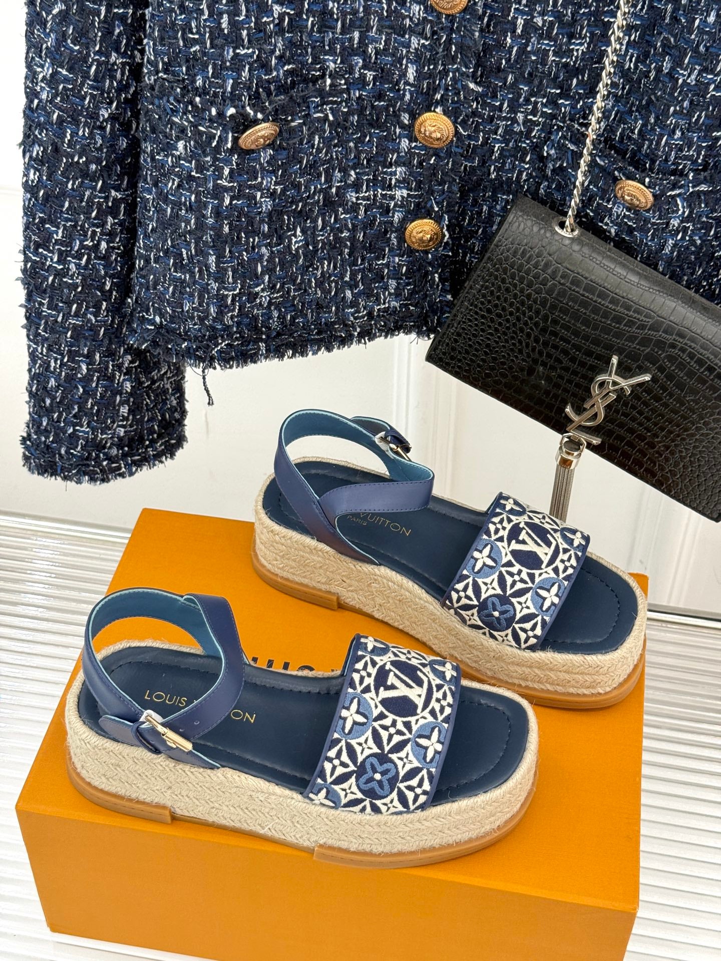 Pair of blue espadrille sandals with monogram canvas front straps on jute sole