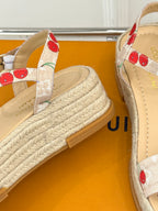 Espadrille wedge sandals showing cherry print ankle strap and jute-textured sole