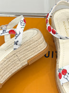 Espadrille sandal close-up: white cherry strap and braided jute platform sole.