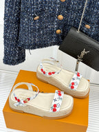 Espadrille sandals with white cherry-pattern straps and braided jute platform sole.