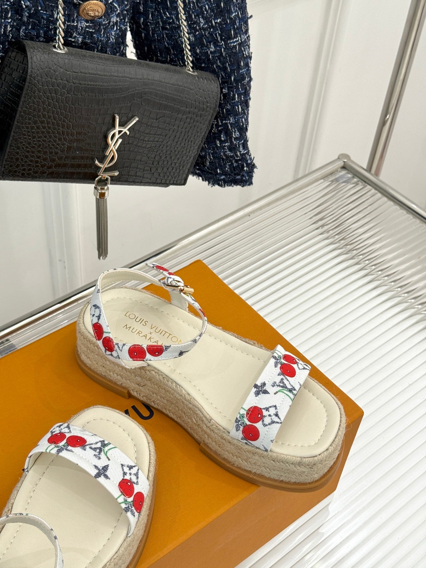 Espadrille slide sandals with white cherry-pattern straps and braided jute sole.