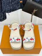 Pair of espadrille sandals with white leather uppers, red cherry print, platform sole.