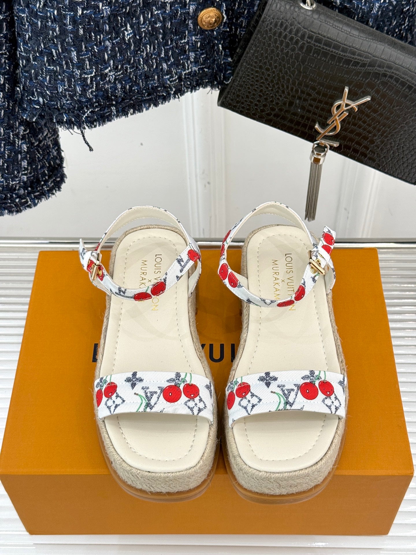 Pair of espadrille sandals with white leather uppers, red cherry print, platform sole.