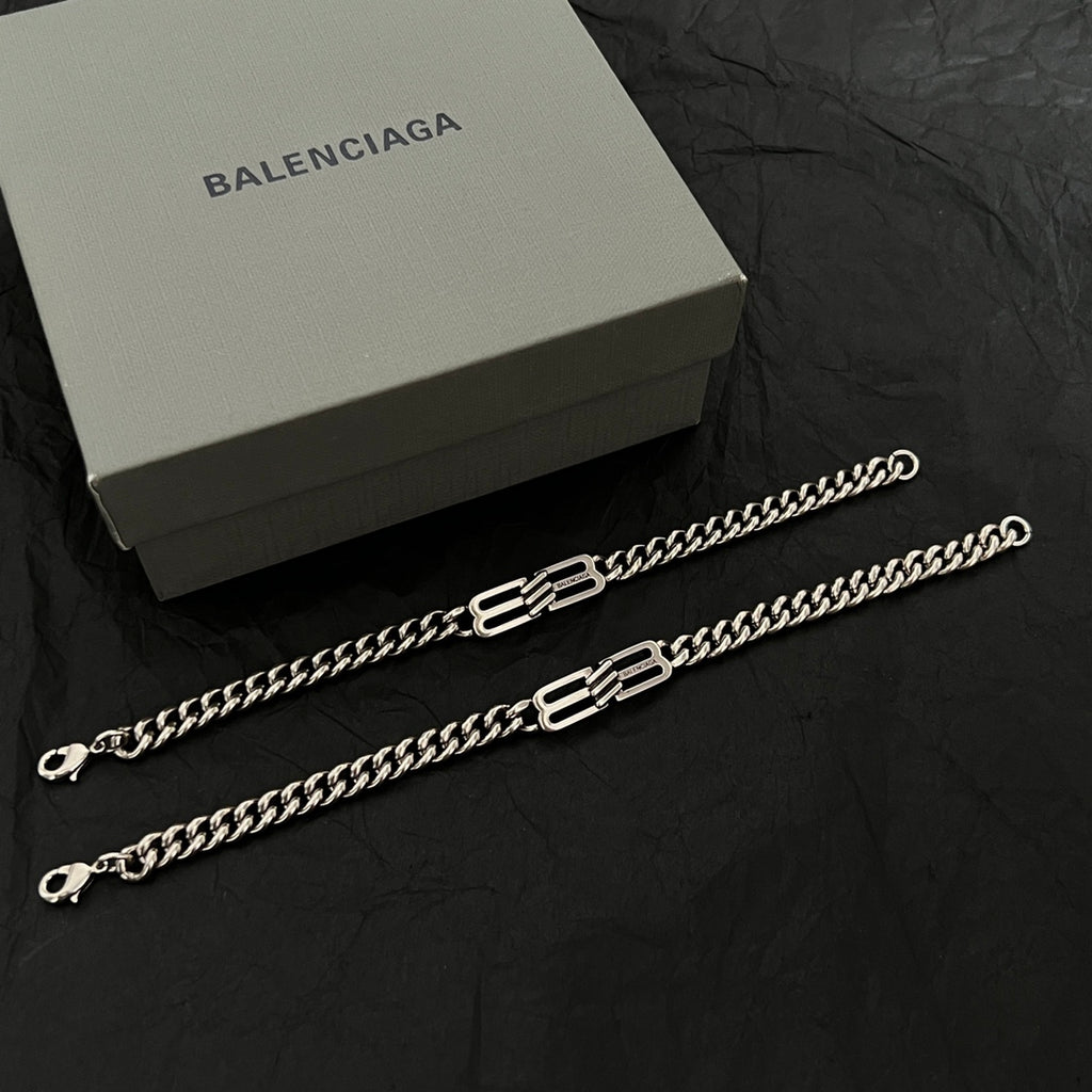 Chain bracelets with interlocking B-style charm elements and lobster clasps