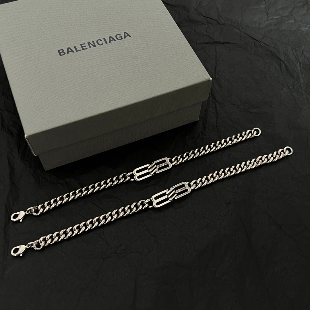 Chain bracelets with interlocking B-style charm elements and lobster clasps