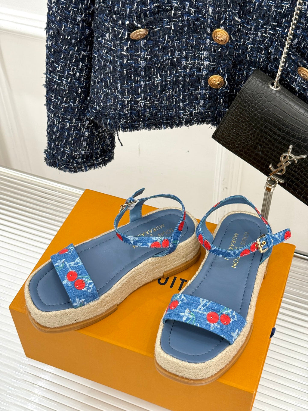 Pair of blue slide espadrille sandals with cherry-print strap details