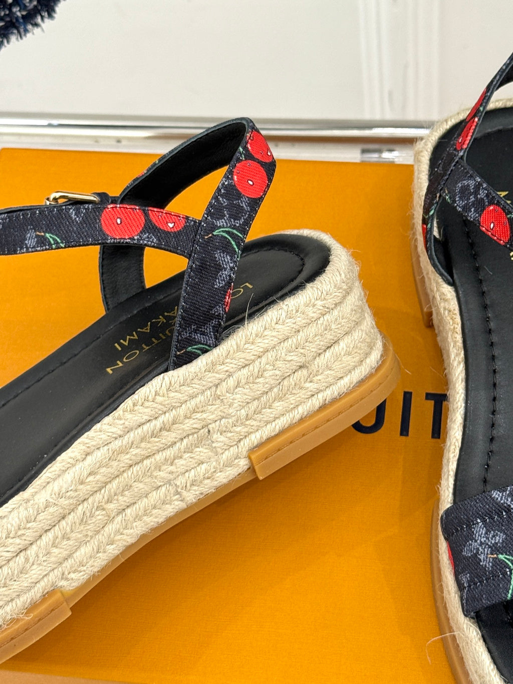 Louis Vuitton black espadrille sandals with cherry-pattern strap details and woven platform sole.