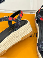 Louis Vuitton black espadrille sandals with cherry-pattern strap details and woven platform sole.