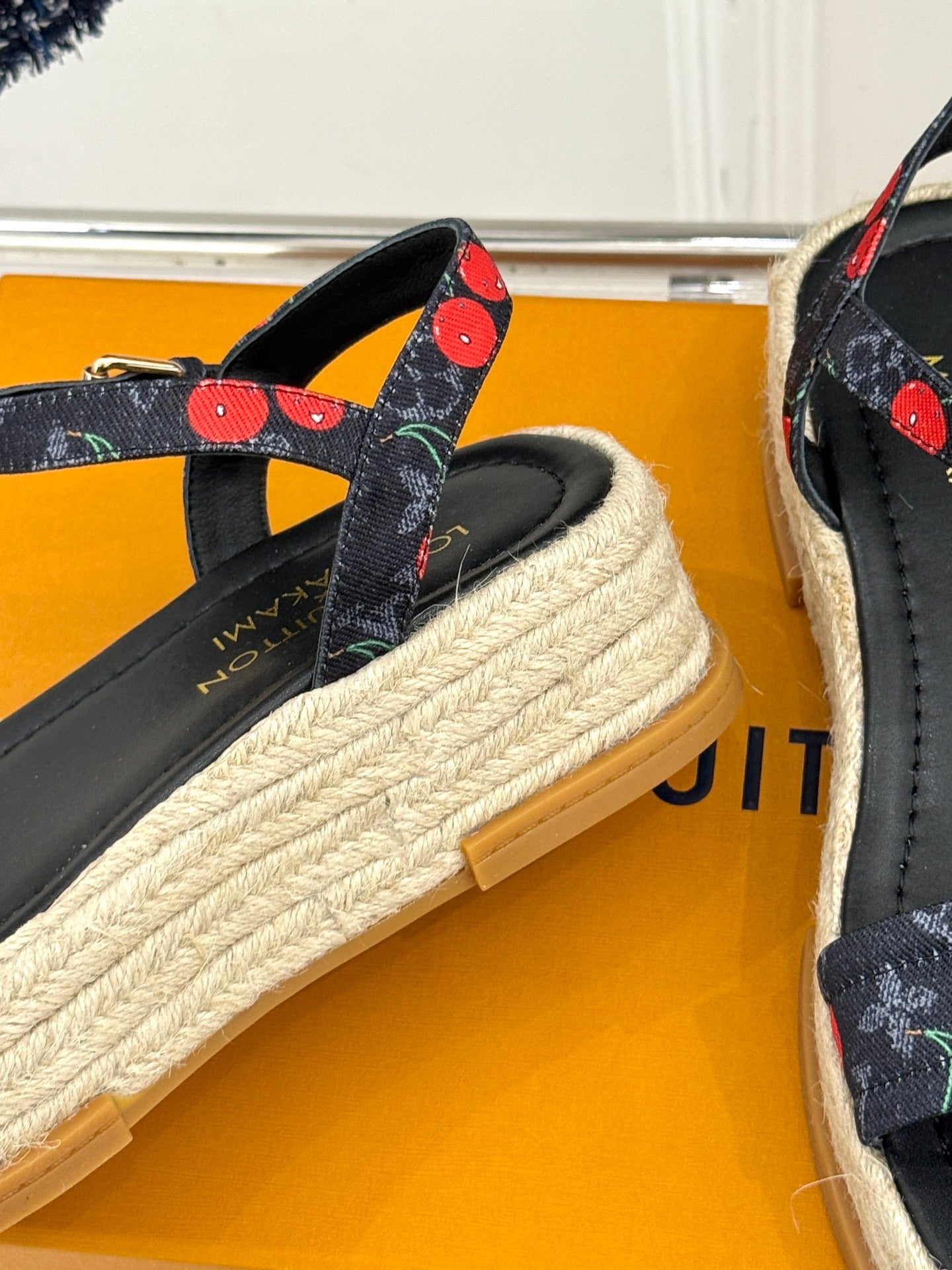 Louis Vuitton black espadrille sandals with cherry-pattern strap details and woven platform sole.